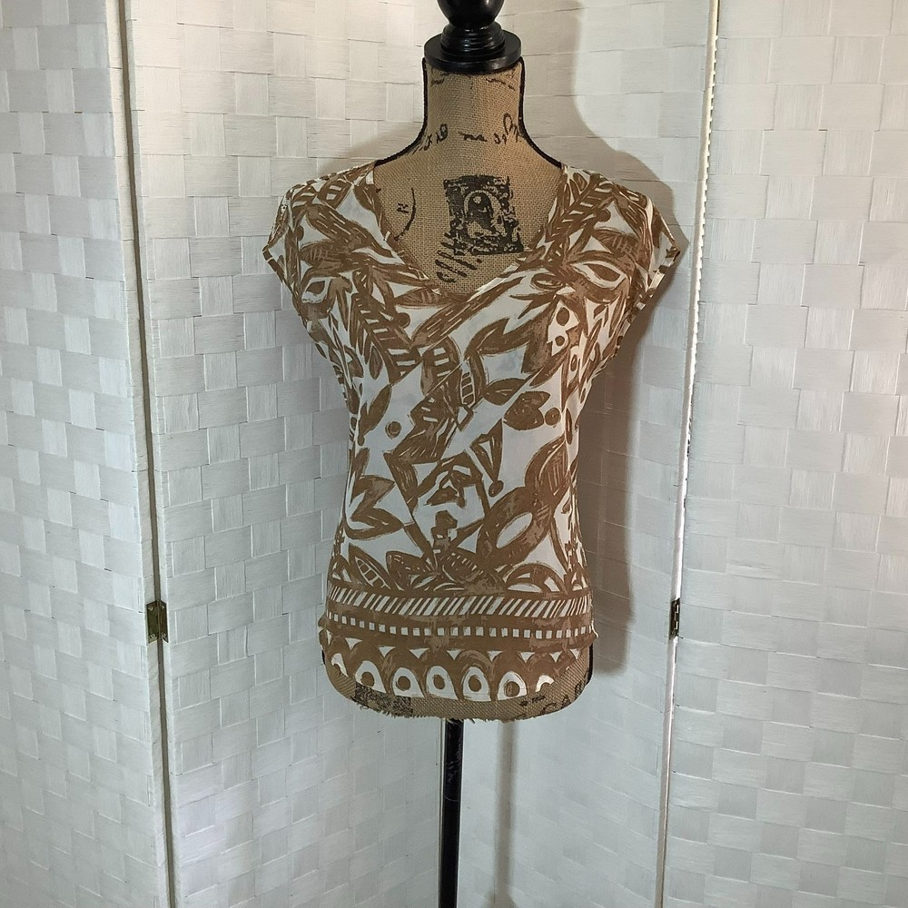 the limited tan, white floral crochet back blouse size XS